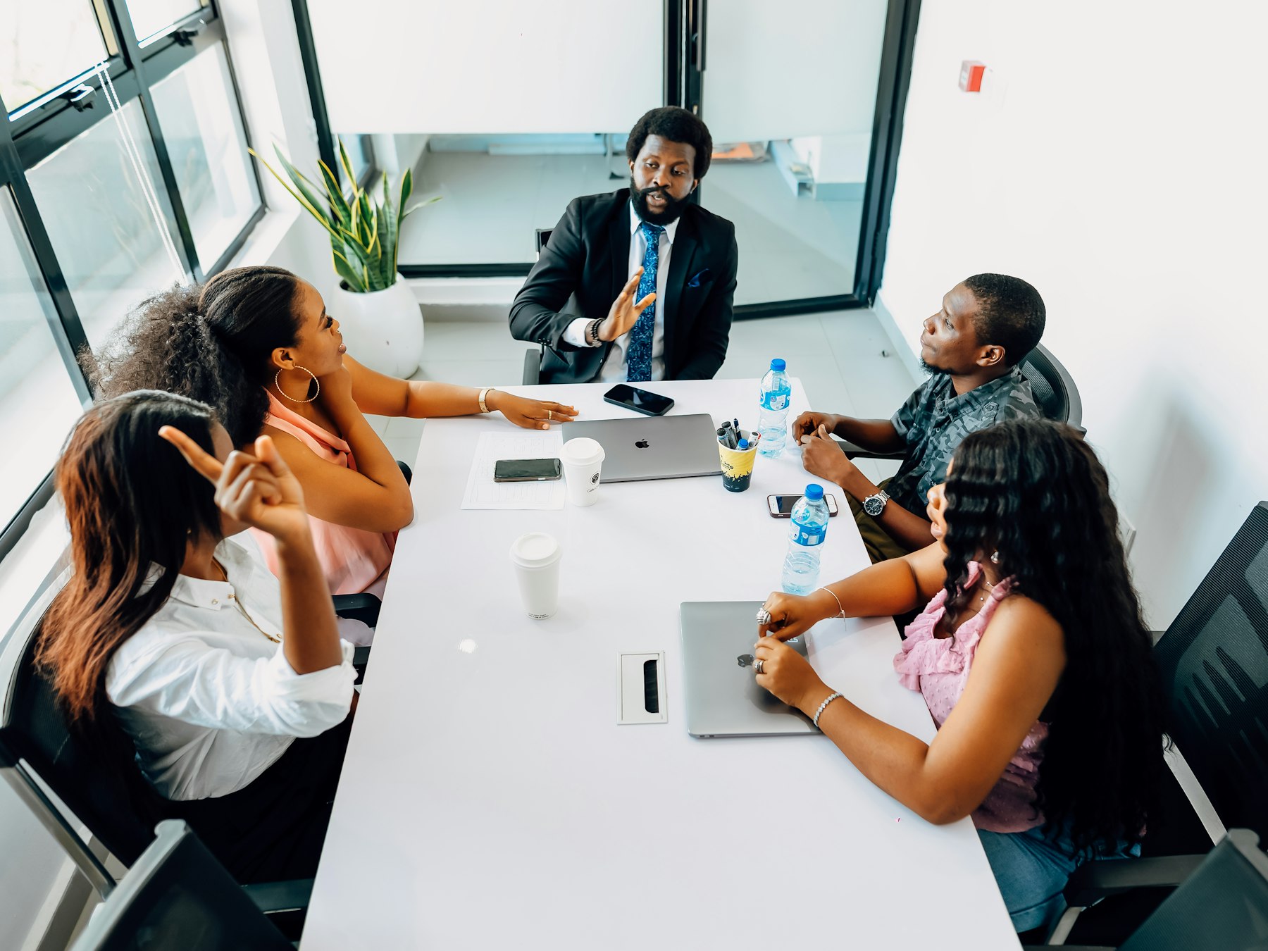 Product and engineering team meeting around a table in an office